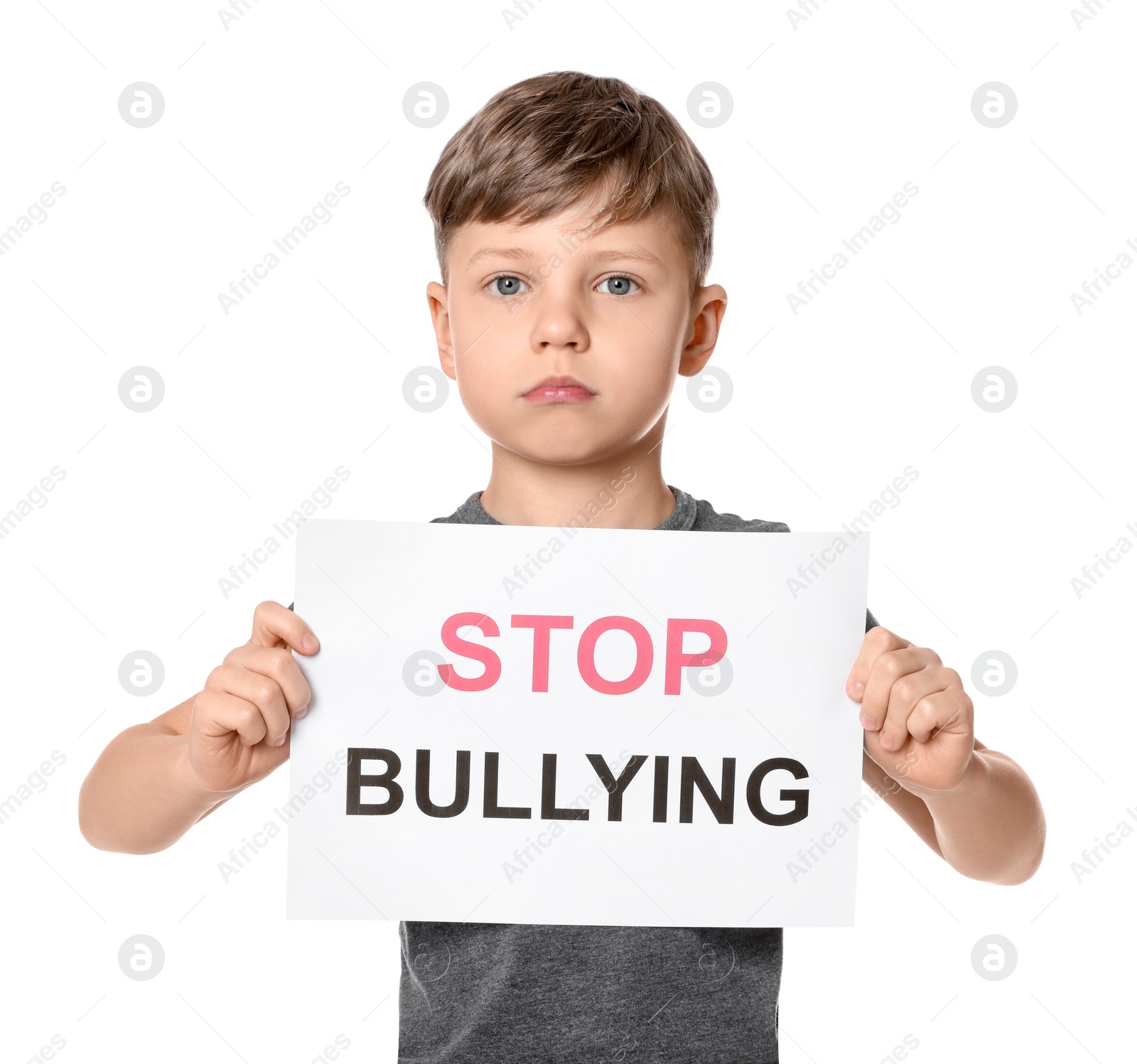Photo of Boy holding sign with phrase Stop Bullying on white background