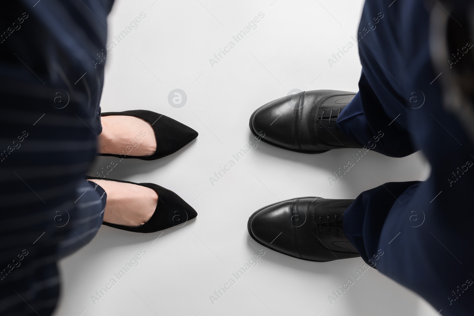 Photo of Businesswoman and businessman on white background, above view