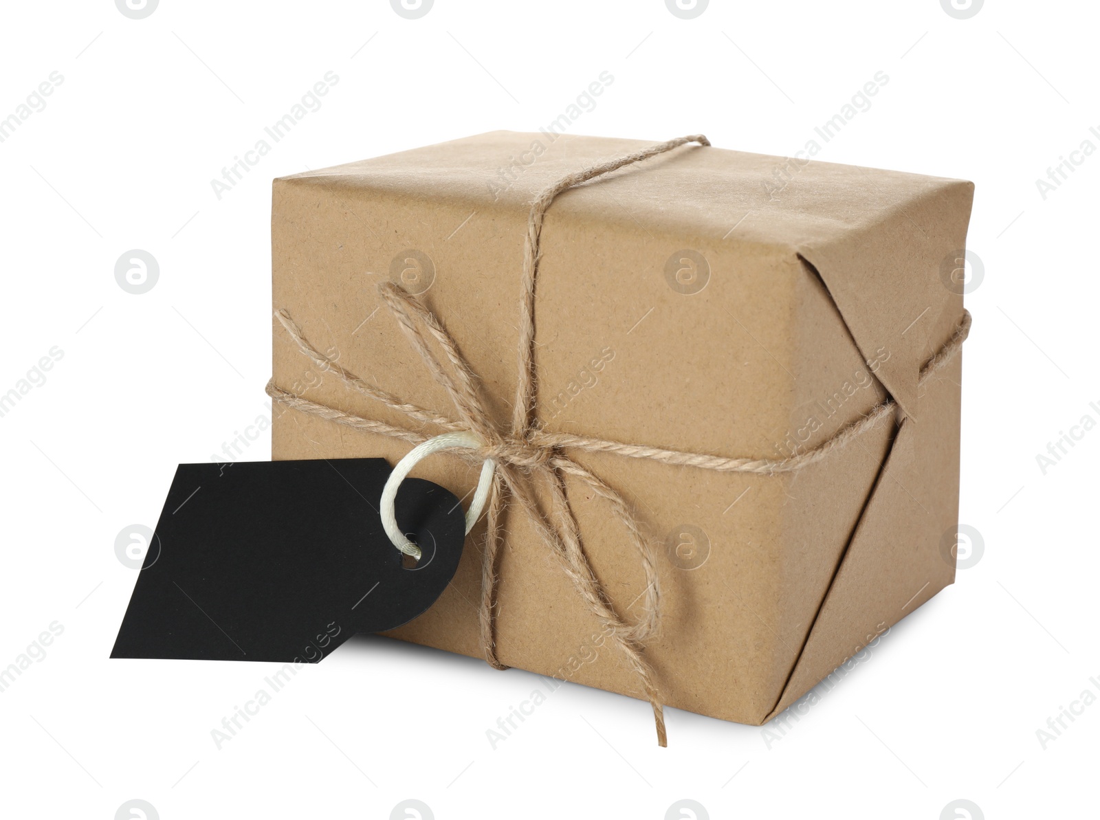 Photo of Parcel wrapped in kraft paper with tag on white background