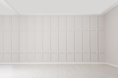 Empty room with beige walls and laminated flooring