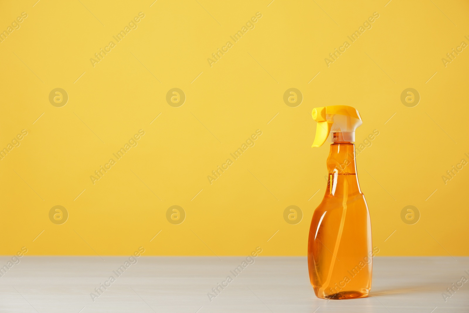 Photo of Bottle of cleaning product on light table. Space for text