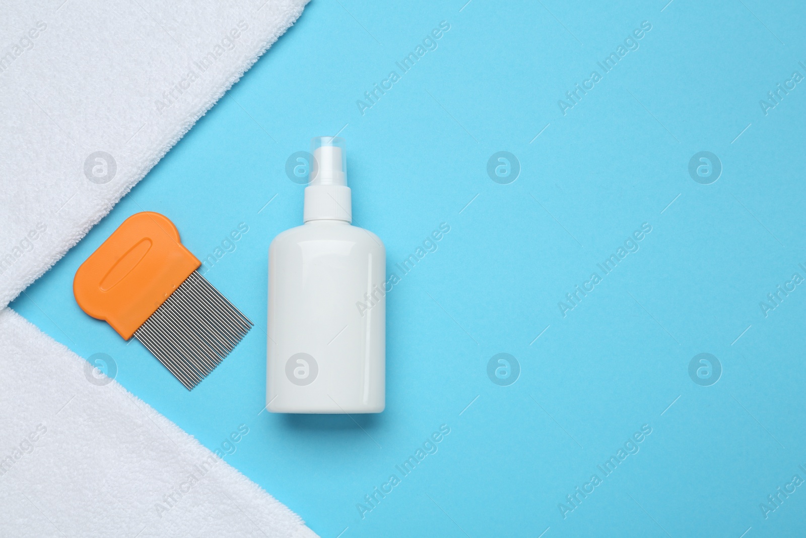Photo of Comb, anti lice spray and towels on light blue background, flat lay. Space for text