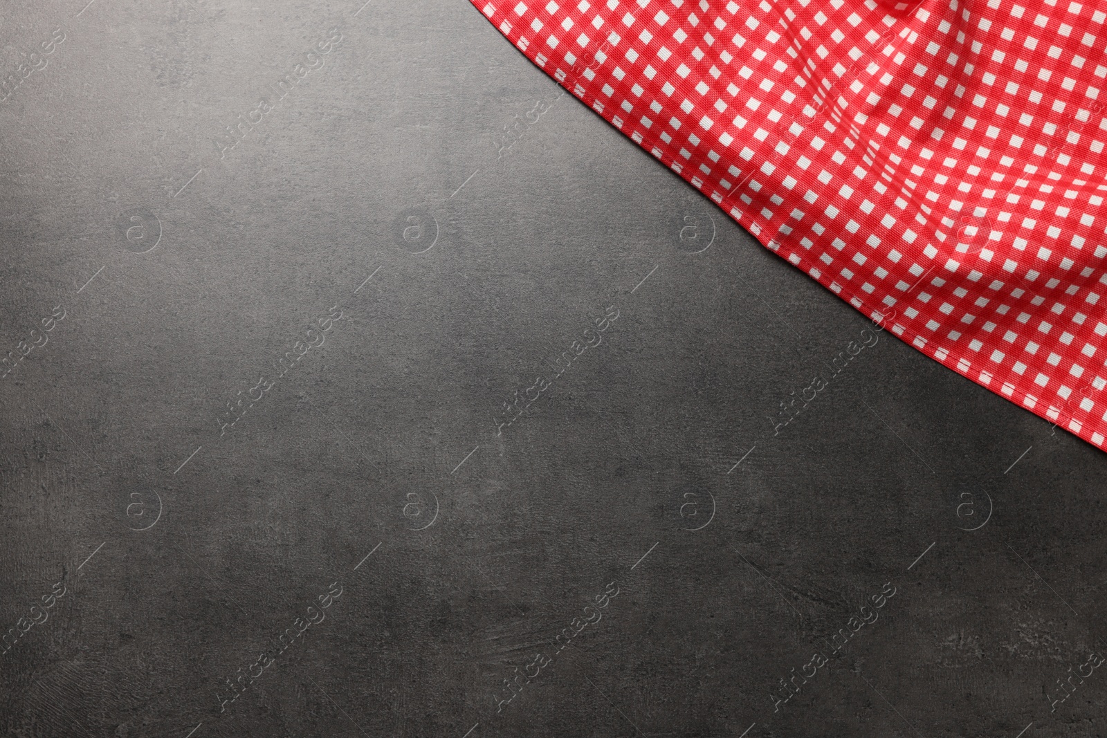 Photo of Checkered tablecloth on grey background, top view. Space for text