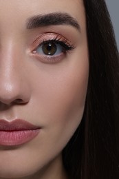 Photo of Beautiful young woman with perfect makeup, closeup view