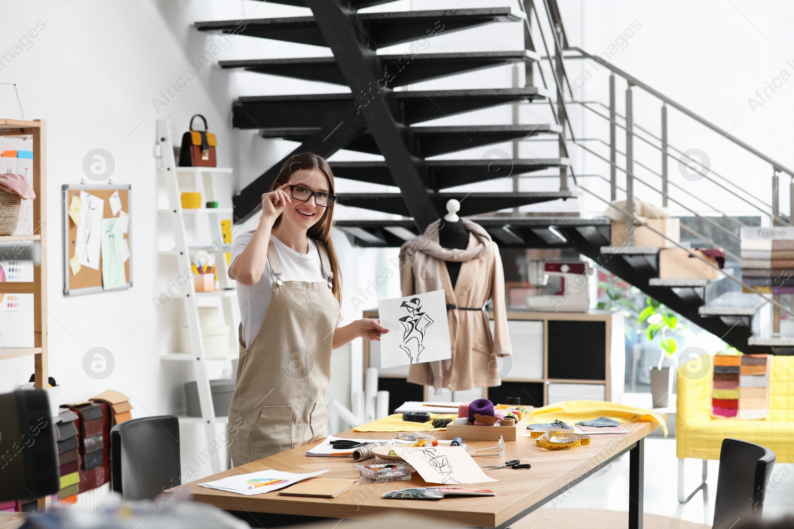 Photo of Fashion designer creating new clothes in studio