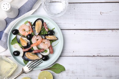 Photo of Plate of delicious salad with seafood on white wooden table, flat lay. Space for text
