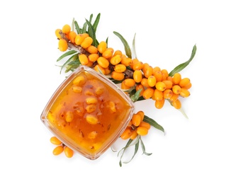 Delicious sea buckthorn jam in bowl and fresh berries on white background, top view