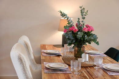 Beautiful table setting with bouquet and candles in room. Space for text