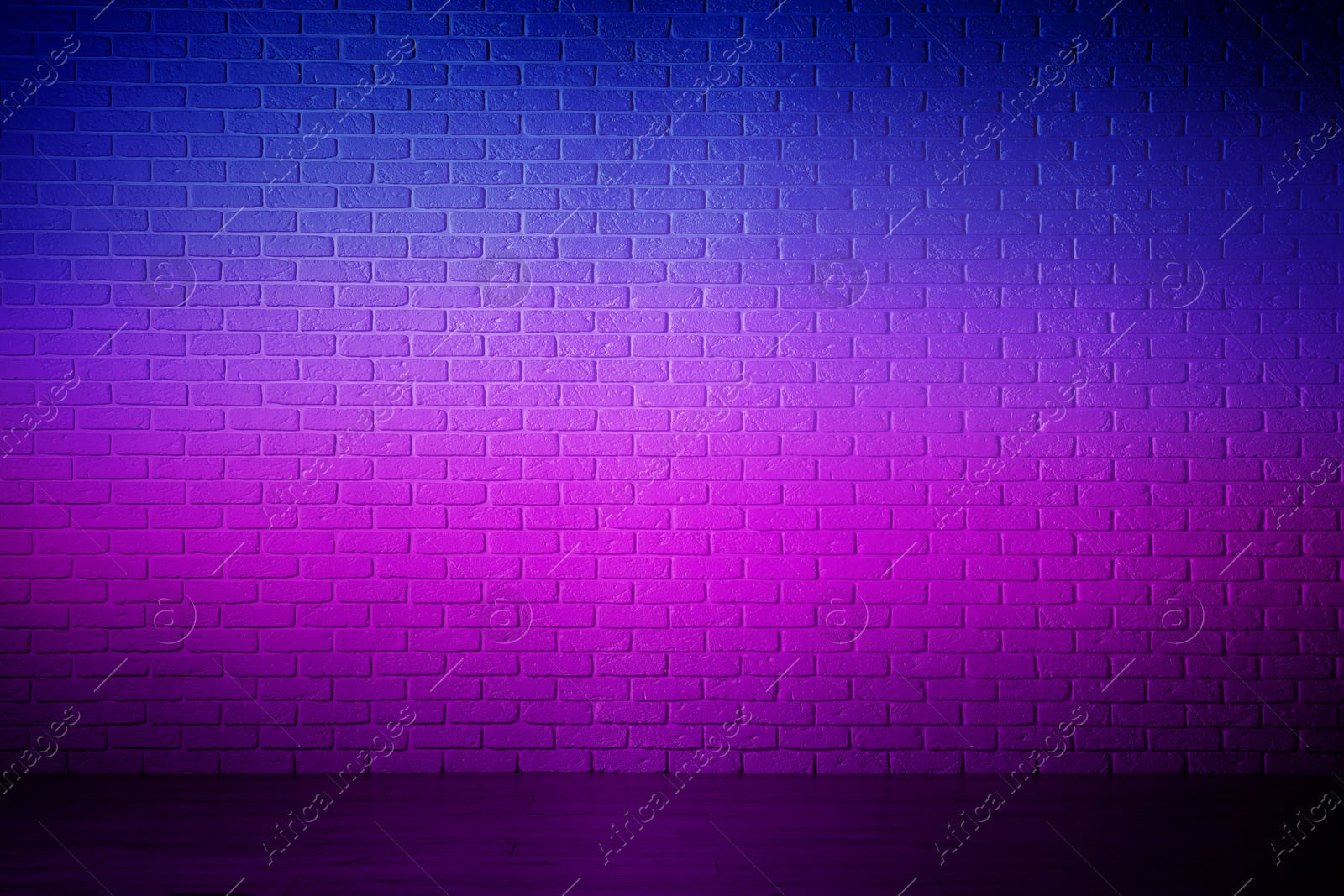 Image of Room with brick wall and wooden floor in neon lights