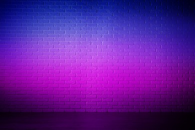 Image of Room with brick wall and wooden floor in neon lights