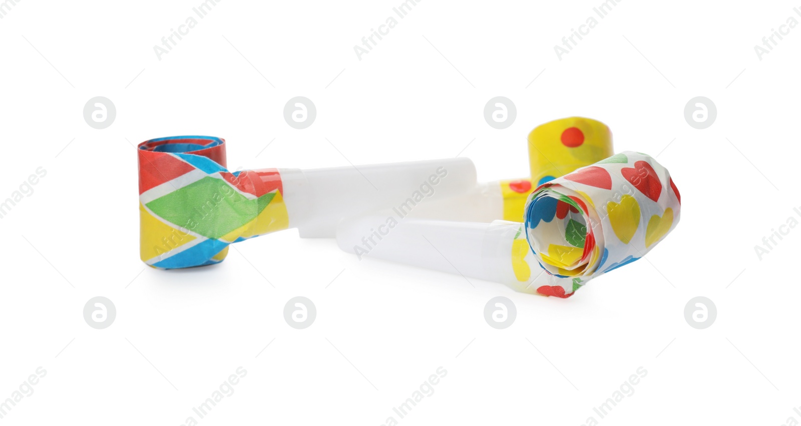 Photo of Bright party blowers on white background. Festive items