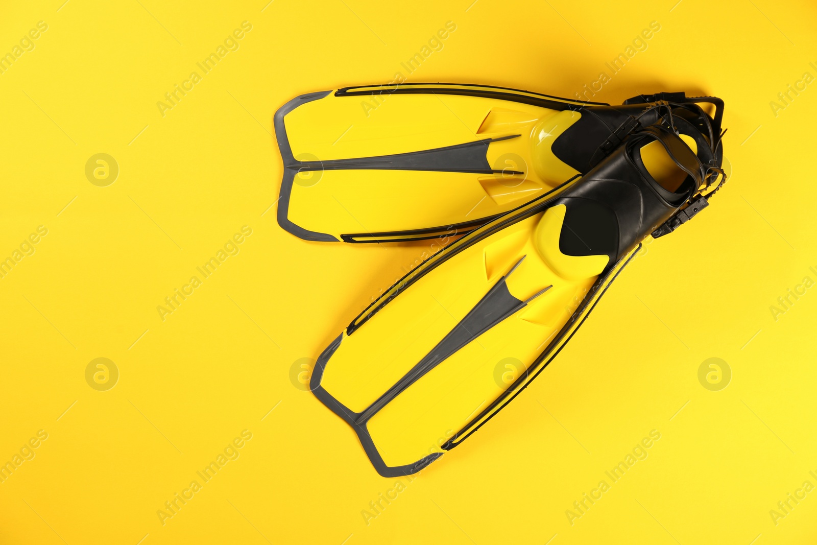 Photo of Swimming flippers on color background, top view. Space for text