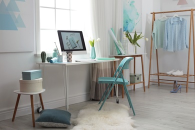 Photo of Stylish workplace interior with modern computer on desk