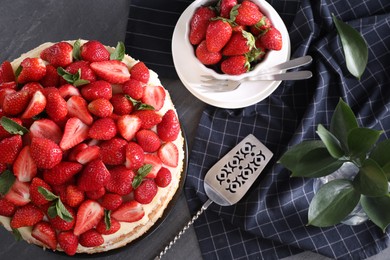 Photo of Tasty cake with fresh strawberries and mint served on table, flat lay