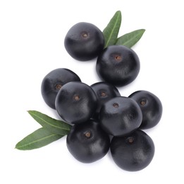 Pile of fresh ripe acai berries and green leaves on white background, top view