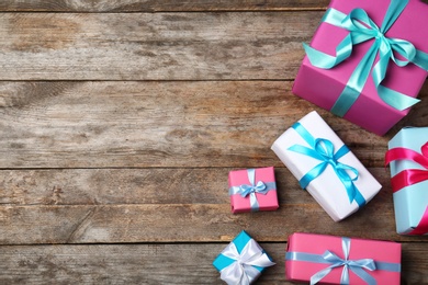 Photo of Flat lay composition with beautiful gift boxes on wooden background