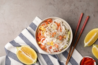 Photo of Flat lay composition with rice noodles in bowl on grey background
