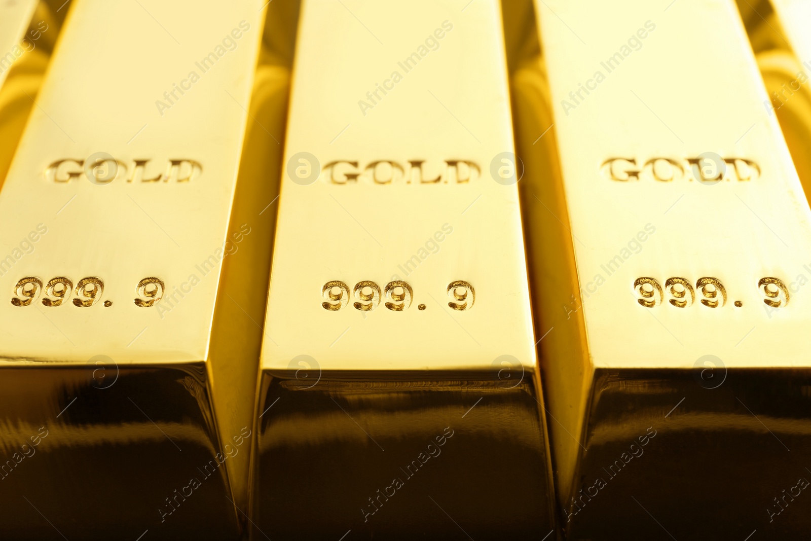 Photo of Shiny sleek gold bars as background, closeup