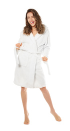 Beautiful young woman wearing bathrobe on white background