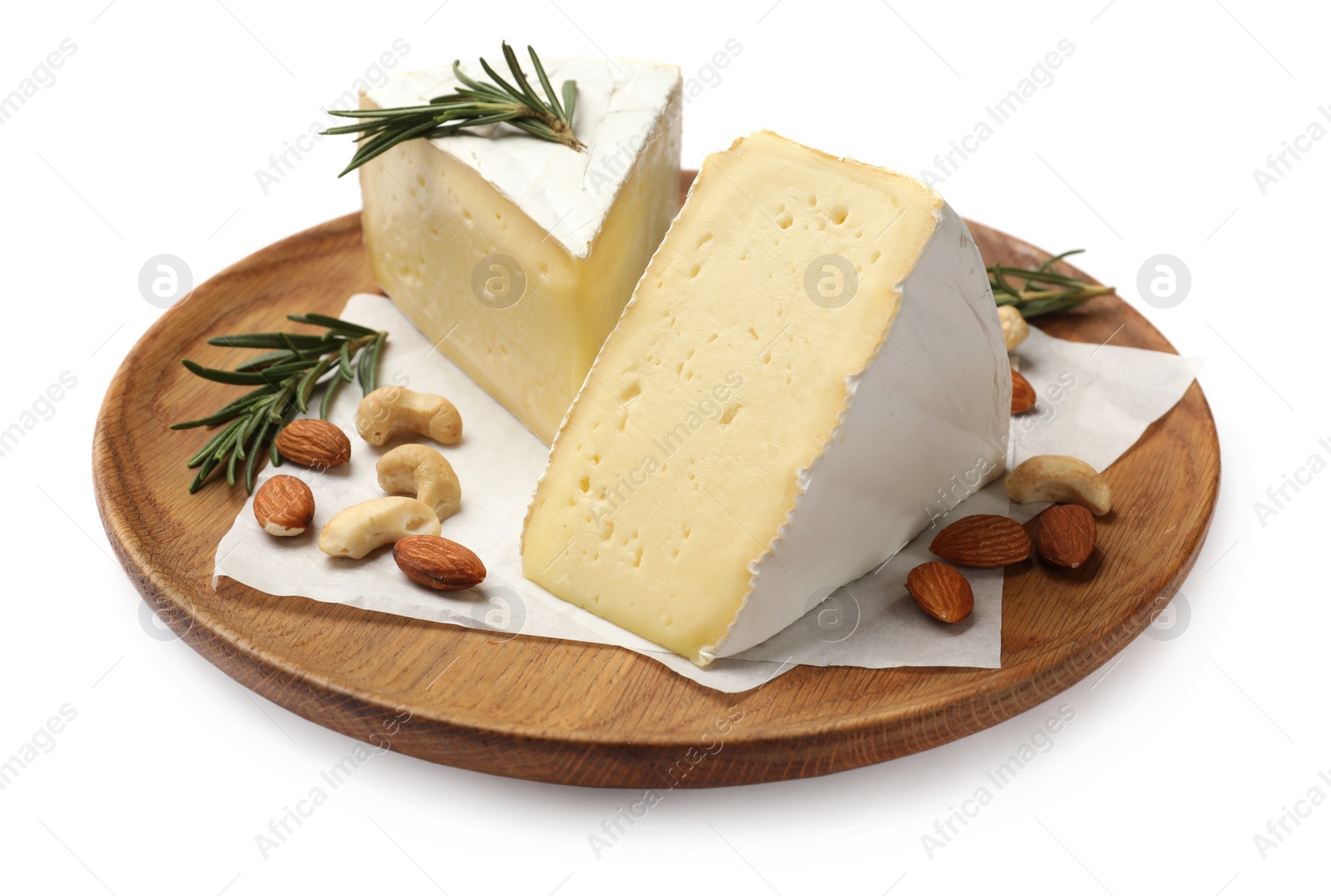 Photo of Plate with pieces of tasty camembert cheese, nuts and rosemary isolated on white