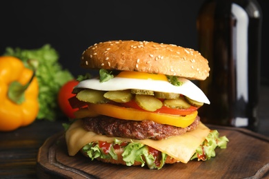 Tasty burger with fried egg on wooden board