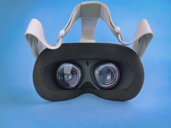Modern virtual reality headset on light blue background