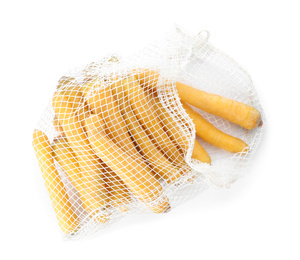 Photo of Raw yellow carrots in mesh bag isolated on white, top view