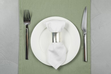 Photo of Stylish setting with elegant cutlery on grey table, top view