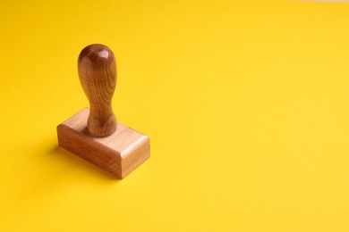 One wooden stamp tool on yellow background, space for text