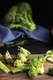 Photo of Raw green broccoli on wooden cutting board