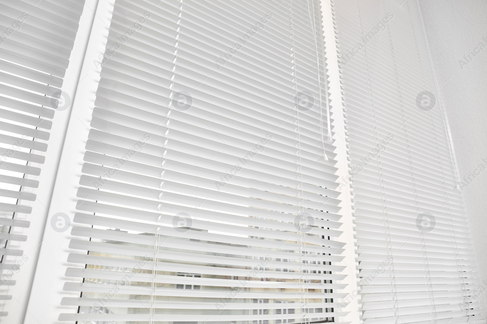 Photo of Window with modern horizontal blinds indoors, closeup