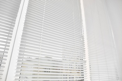 Photo of Window with modern horizontal blinds indoors, closeup