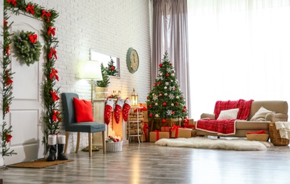 Photo of Stylish interior with Christmas tree and decorative fireplace