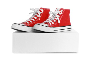 Photo of Pair of stylish sport shoes and box on white background