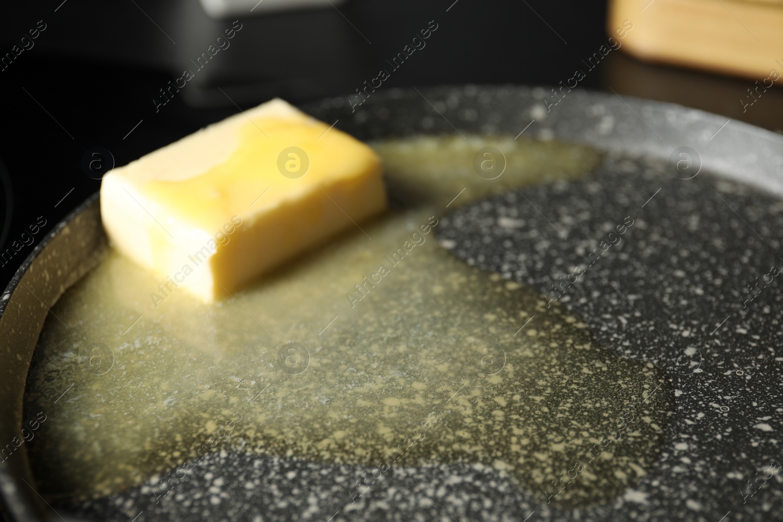 Photo of Melting butter in frying pan, closeup view