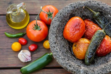 Ingredients for tasty salsa sauce and stone bowl on wooden table, flat lay