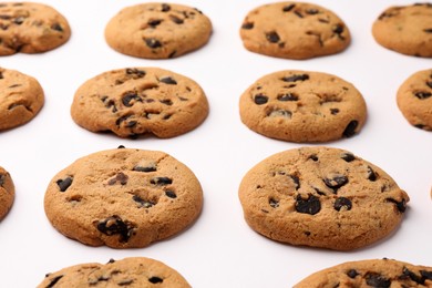 Photo of Many delicious chocolate chip cookies on white background, closeup