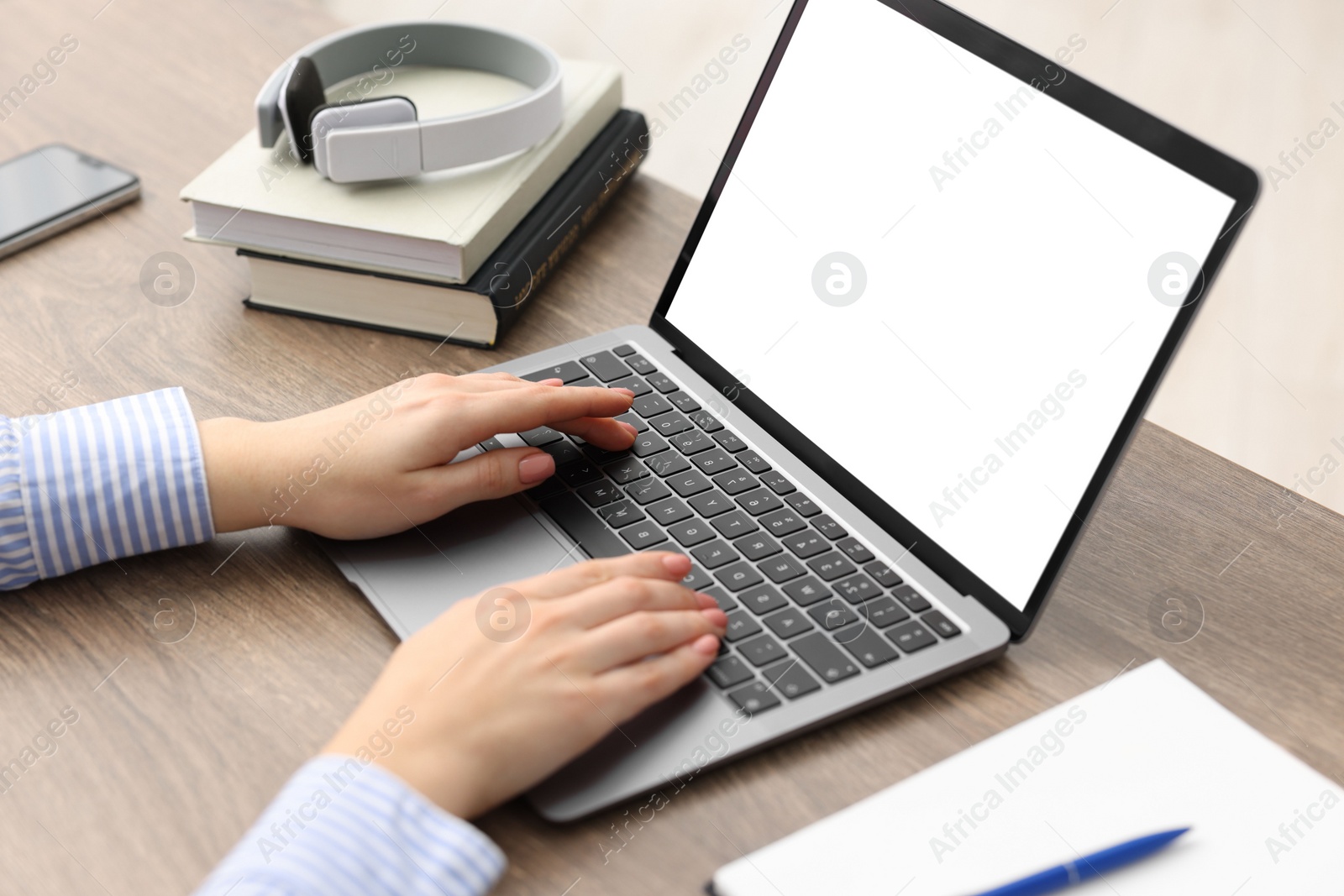 Photo of E-learning. Woman using laptop during online lesson indoors, closeup