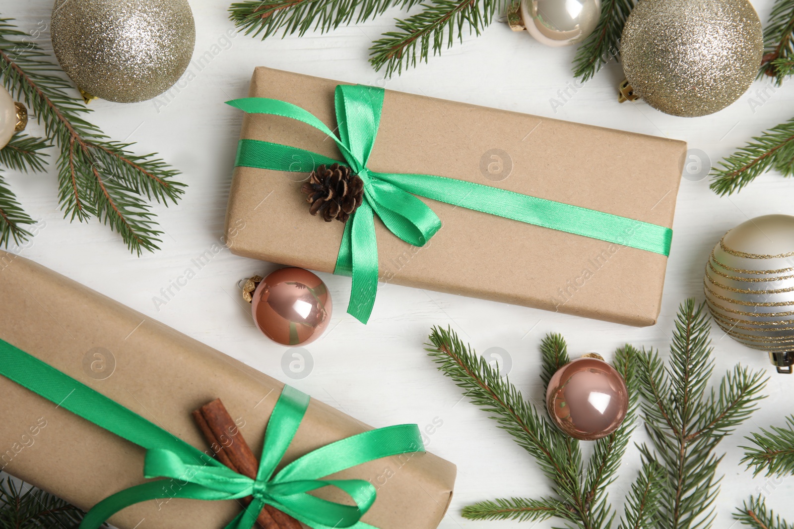 Photo of Flat lay composition with Christmas gift boxes on white wooden table