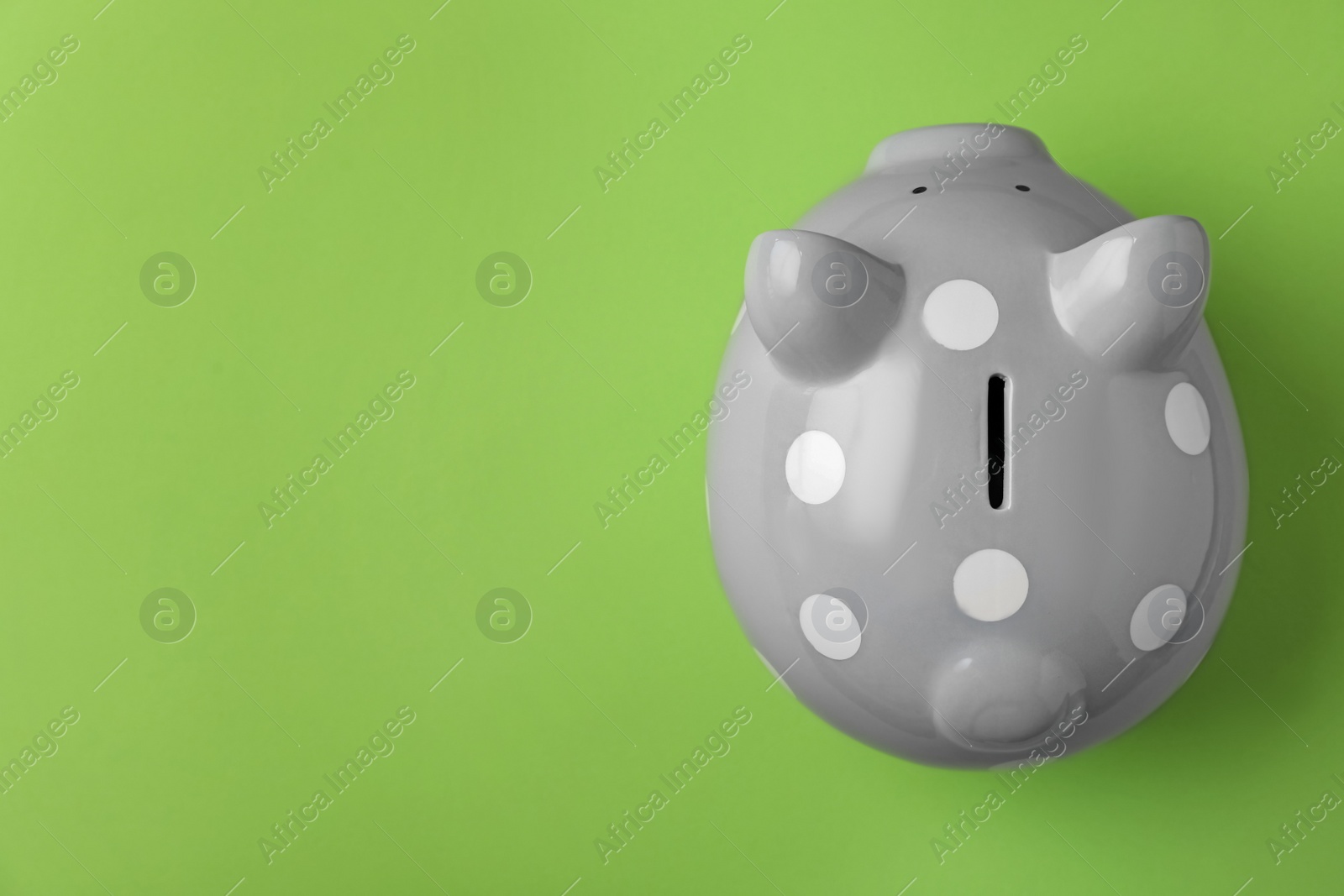 Photo of Gray piggy bank on color background, top view