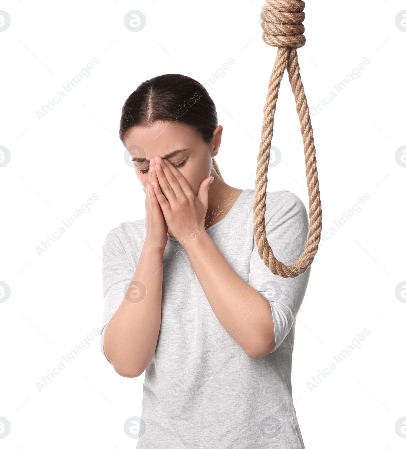 Photo of Depressed woman with rope noose on white background