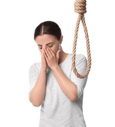 Photo of Depressed woman with rope noose on white background