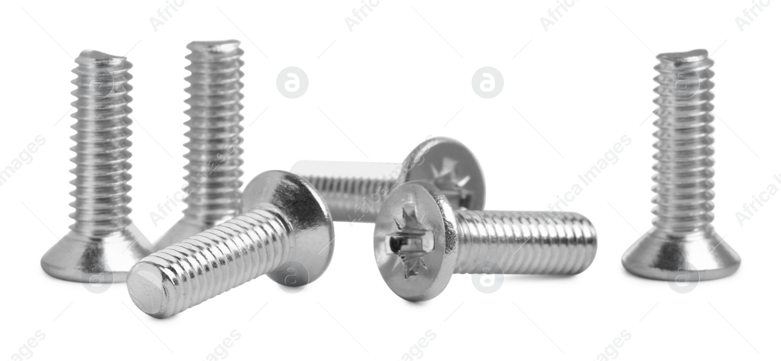 Photo of Many metal machine screw bolts on white background