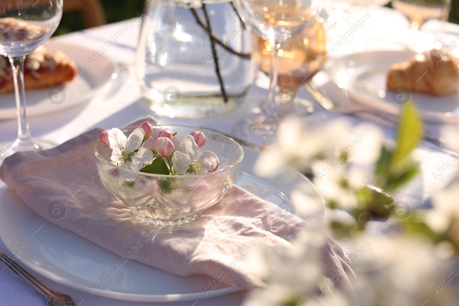 Photo of Stylish table setting with beautiful spring flowers in garden