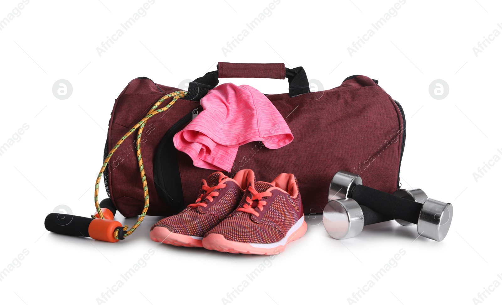 Photo of Sports bag and gym equipment on white background