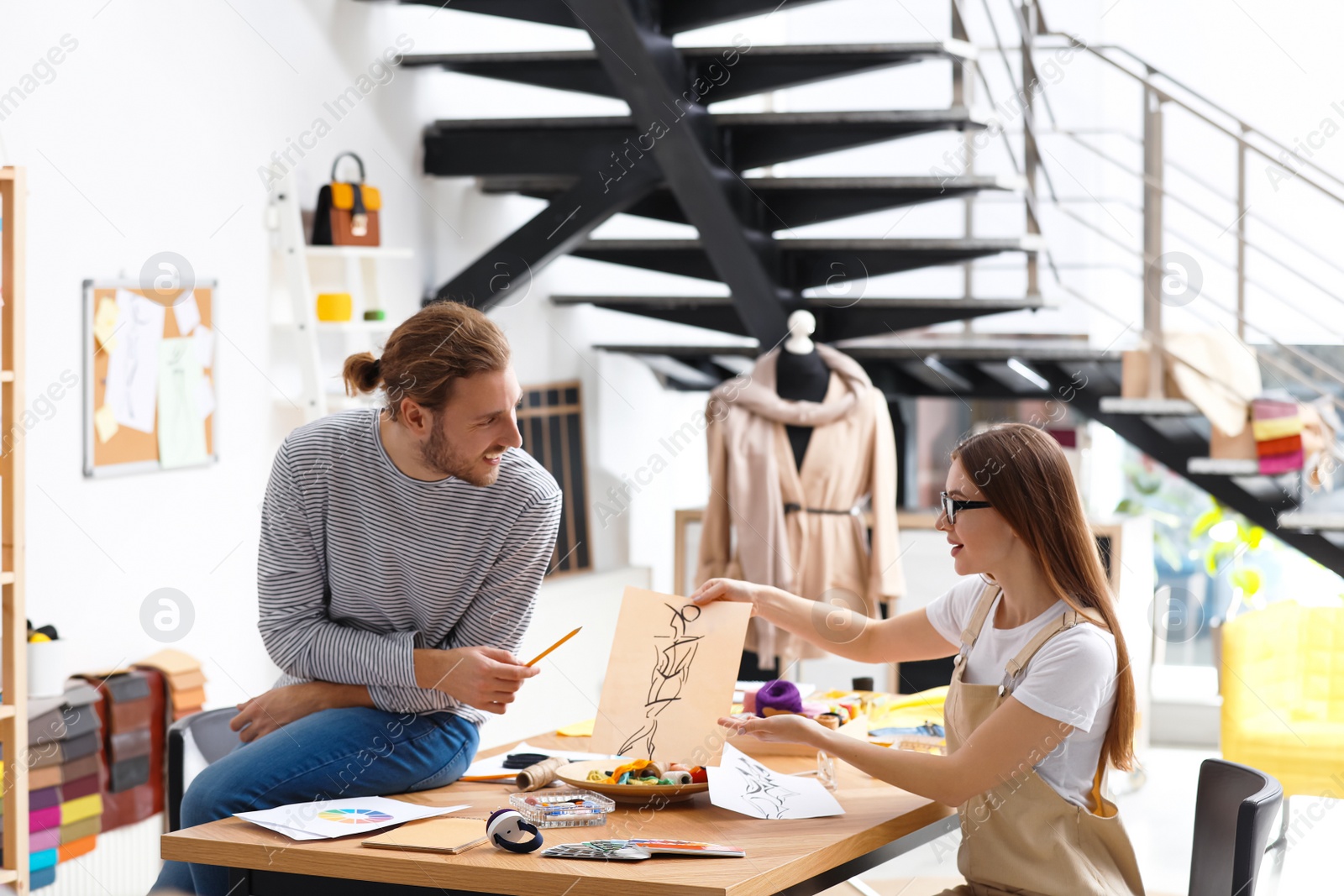 Photo of Fashion designers creating new clothes in studio