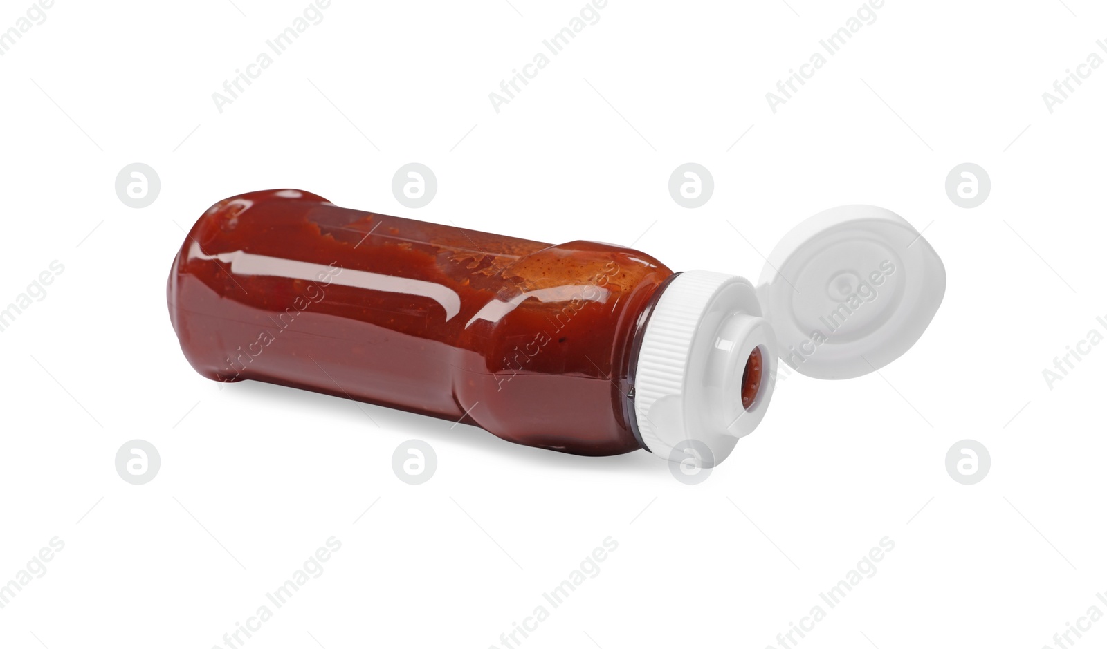 Photo of Bottle of tasty ketchup isolated on white