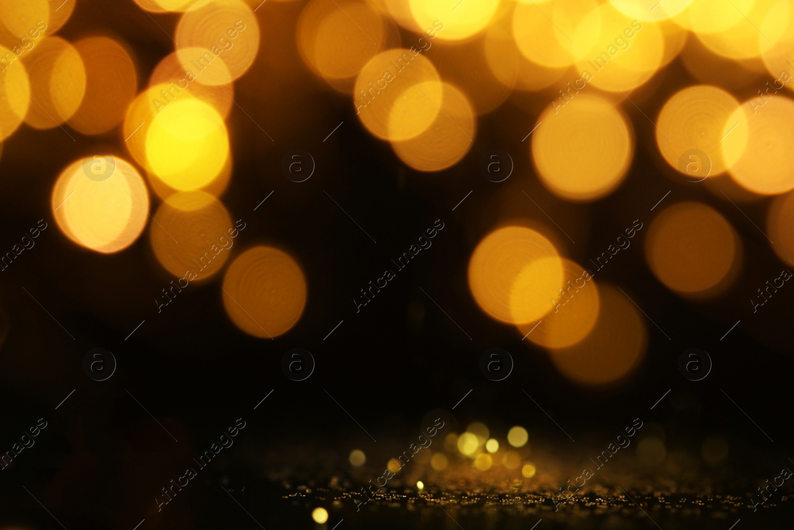Photo of Gold glitter with bokeh effect on black background