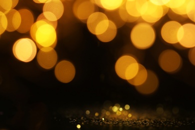 Gold glitter with bokeh effect on black background