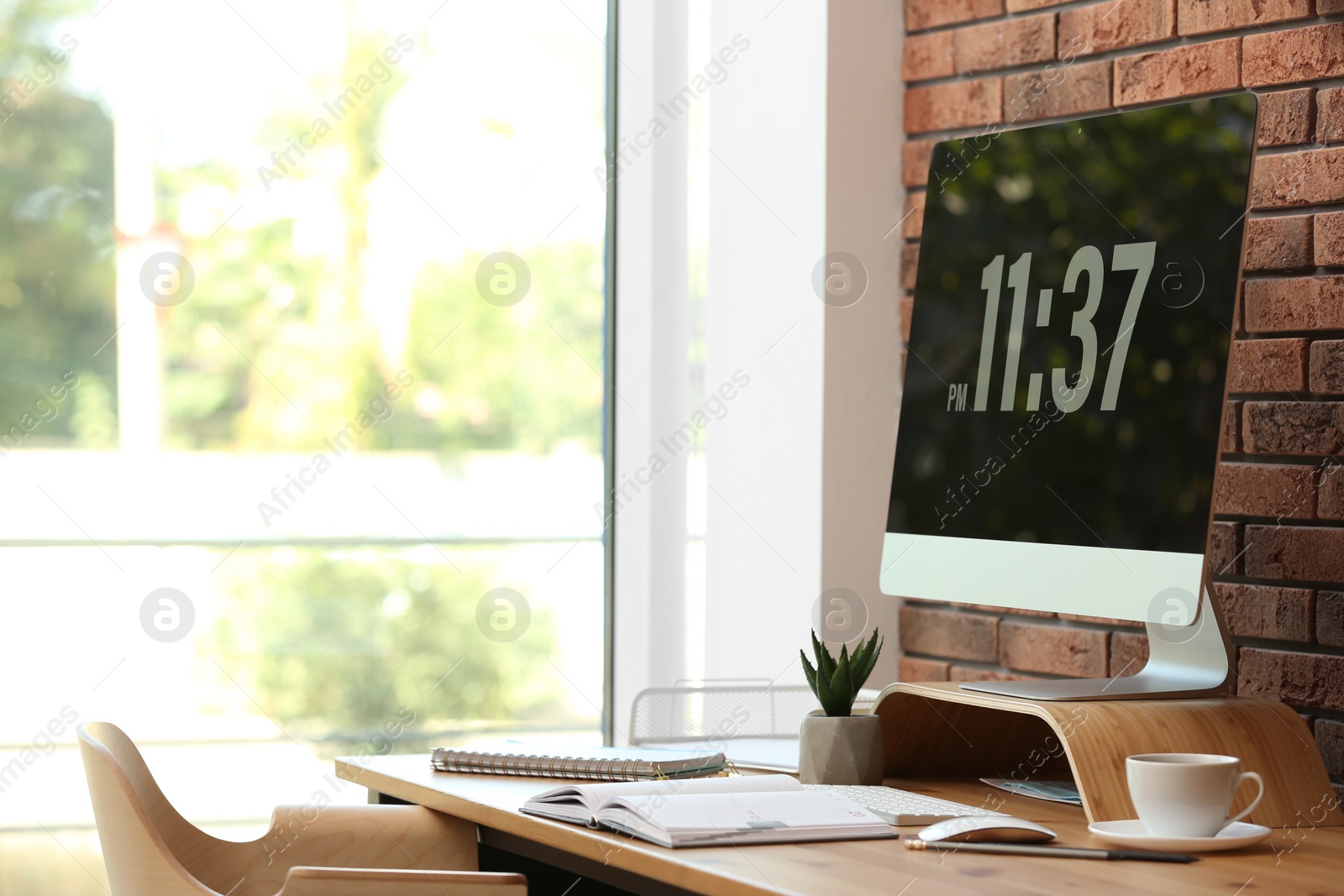 Photo of Modern computer and supplies on table in office. Space for text